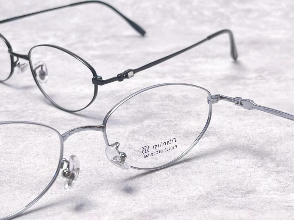 Three pairs of glasses that look almost identical on a counter, made from three different frame materials